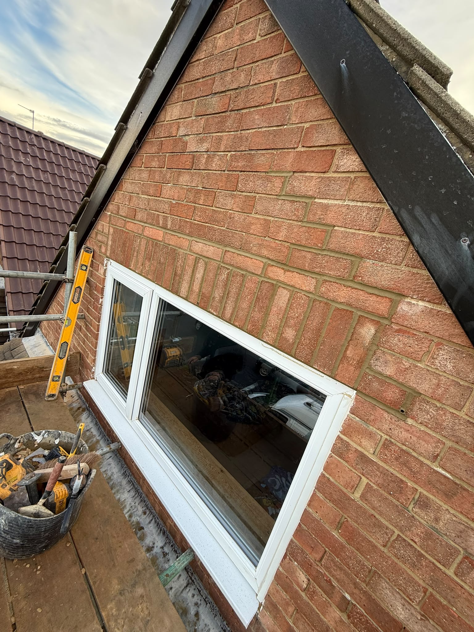 New steel beam and brickwork installed in a gable wall during structural alterations