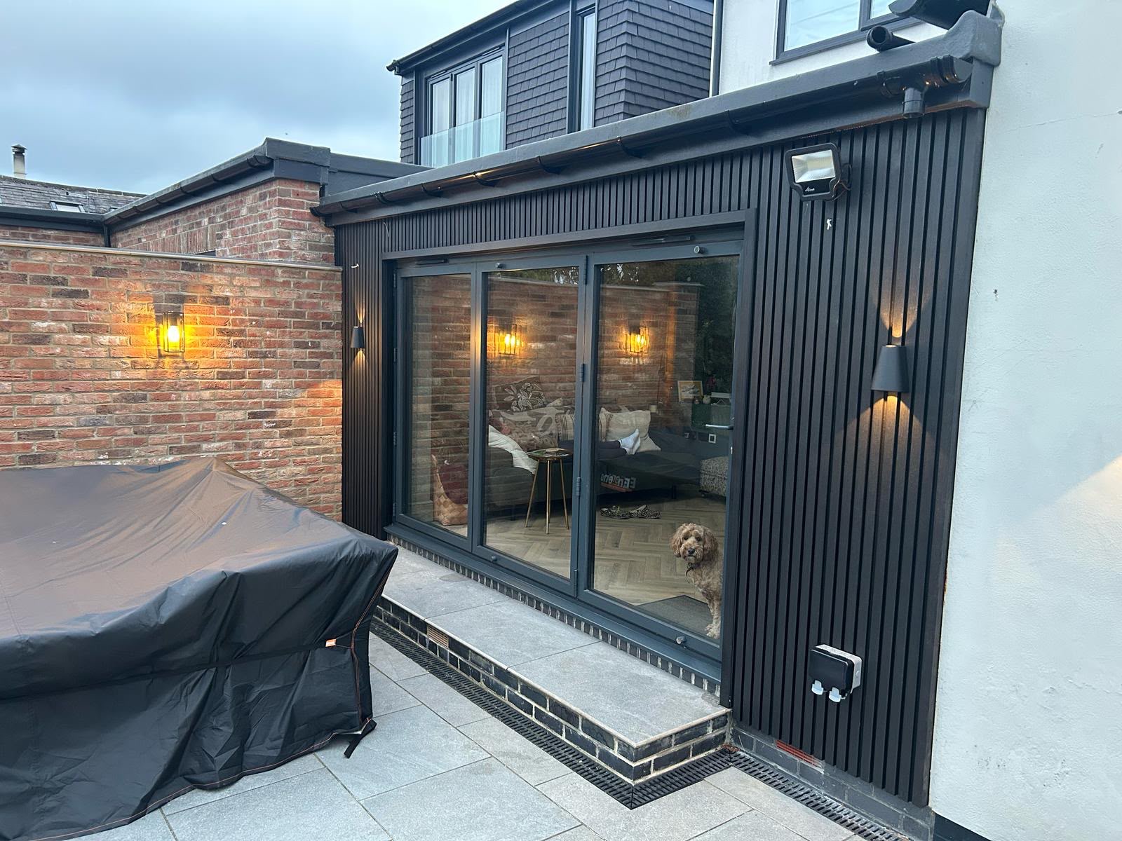 Completed rear extension by Altus Building Co with black slatted cladding and bifold doors
