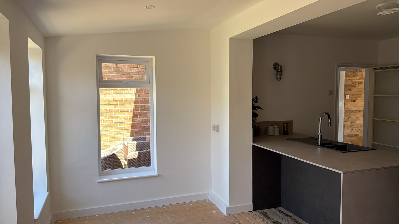 After — the new kitchen seen through the wide structural opening