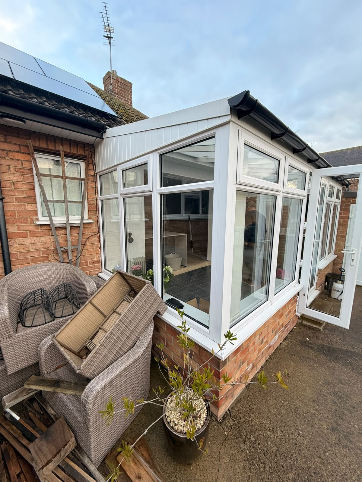 Before — the original uPVC conservatory from the garden