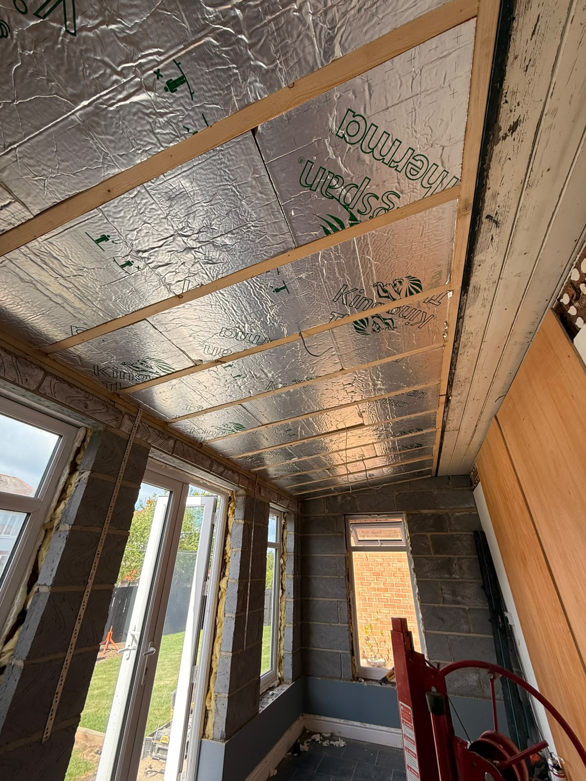 During — insulated roof panels and new rafters going in overhead