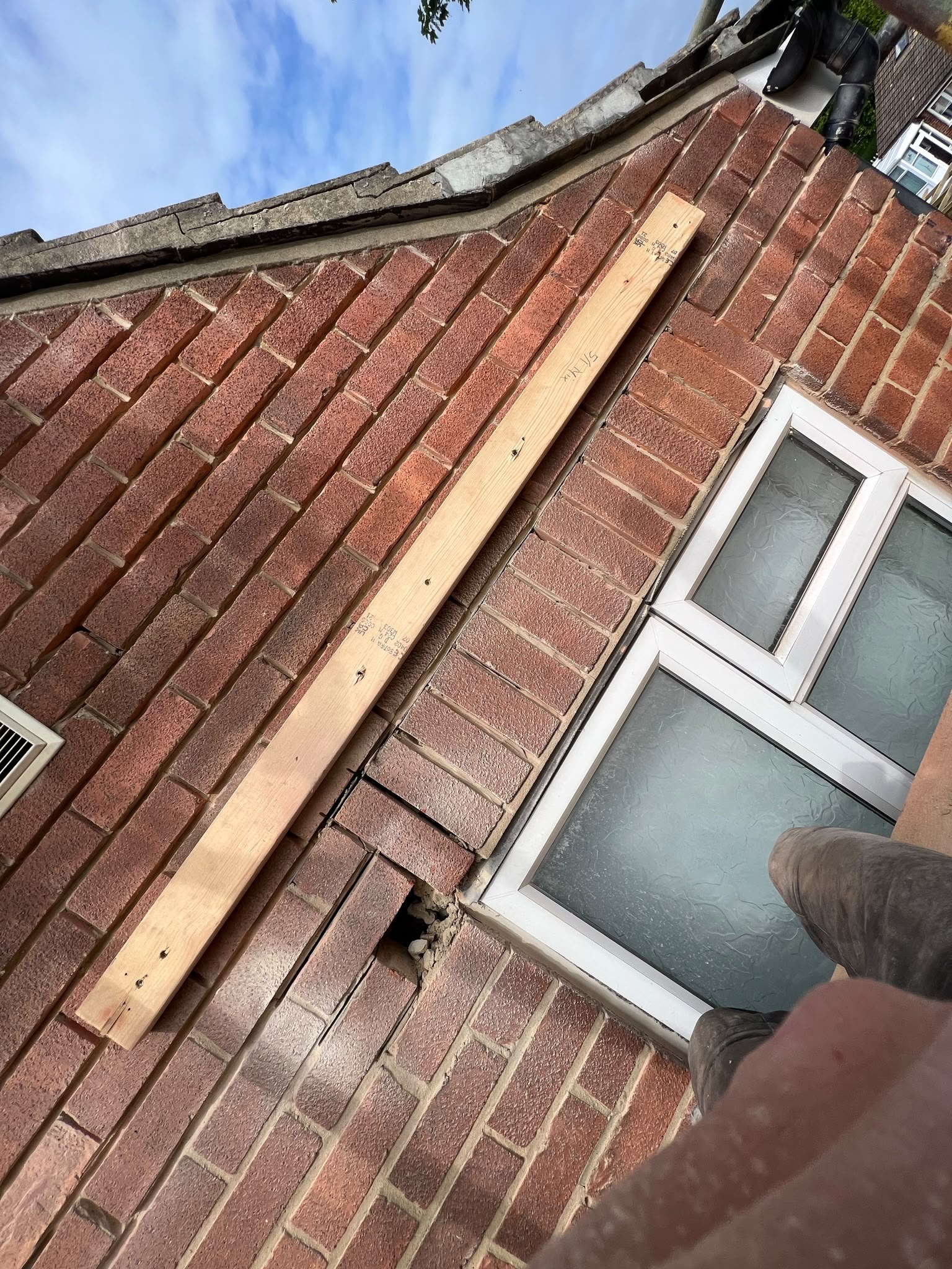 Dropped brickwork at gable level, temporarily supported before the new lintels went in