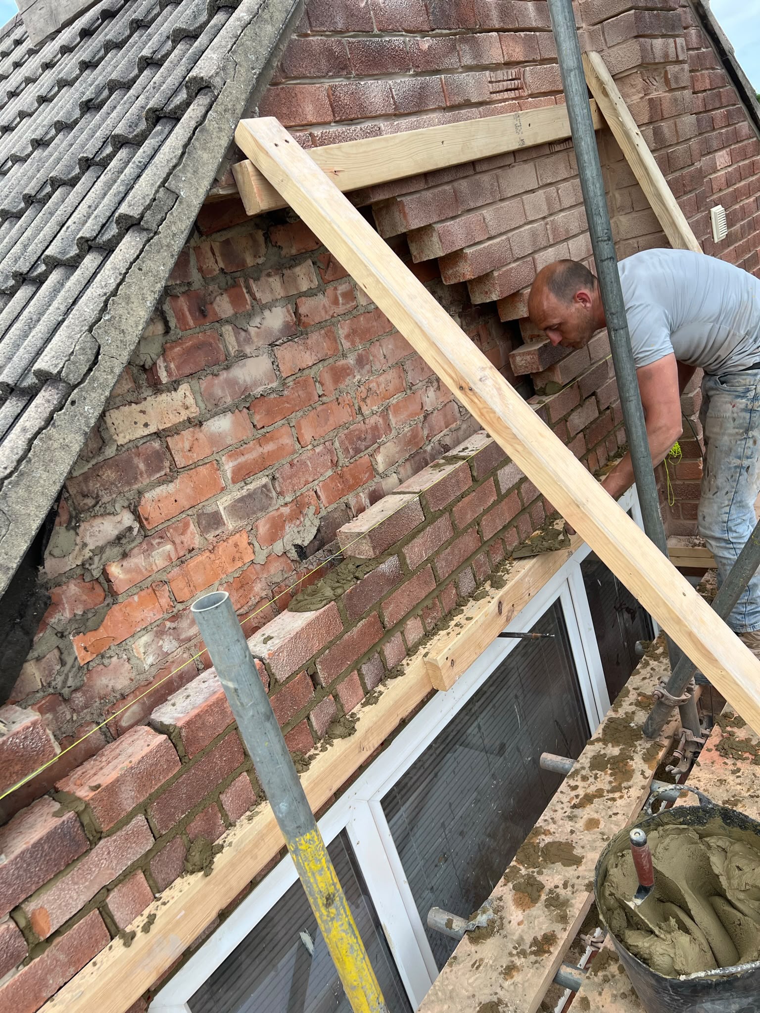 Working at roof level on the brickwork